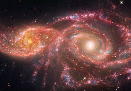 These eyes are actually the cores of two galaxies. The smaller spiral galaxy on the left is IC 2163. It has been slowly 'creeping' behind the larger galaxy, NGC 2207. (Image Credit: NASA, ESA, CSA, STSci)